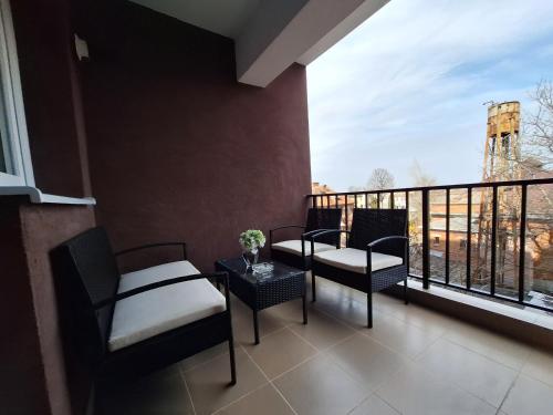 a balcony with two chairs and a table with a view at RONApartament in Bacău