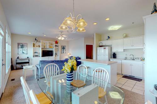 a kitchen and living room with a table and chairs at Peace on the sound, fun on the Beach in Indian Beach