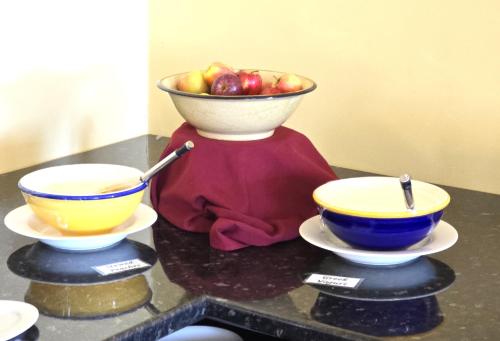 two bowls and a bowl of apples on a table at Palais Royale in Katoomba