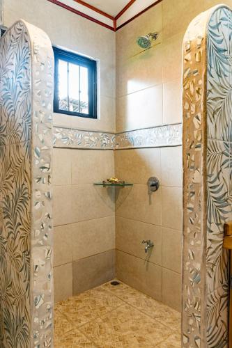 a shower with a glass door in a bathroom at Casa BEA 1 in Sámara