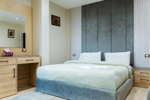 a bedroom with a large bed and a mirror at Mirage pyramids view hotel in Cairo