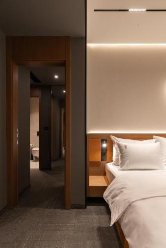 a hotel room with a bed and a bathroom at Garni Hotel Galeria in Banja Luka