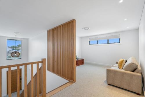 a living room with a staircase and a chair at Mooncoin on Yarran in Evans Head
