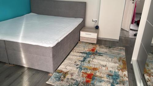 a bedroom with a bed and a rug on the floor at Rodinný dům v klidném prostředí in Slavkov pod Hostýnem