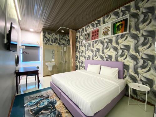 a bedroom with a bed and a wall mural at Duck House Hostel & Resort Khon Kaen in Ban Pet