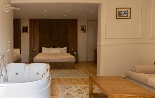a bedroom with a bed and a tub in a room at Mirage pyramids view hotel in Cairo