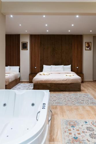 a bedroom with a bed and a bath tub at Mirage pyramids view hotel in Cairo