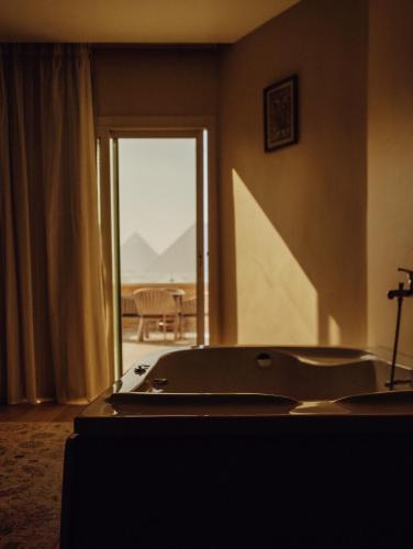 a view of a room with a door leading to a patio at Mirage pyramids view hotel in Cairo