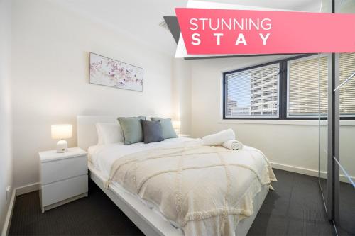 a bedroom with a bed and a sign that reads shining stay at Highlife on Grenfell - 3BR, Wifi, Workspace in Adelaide