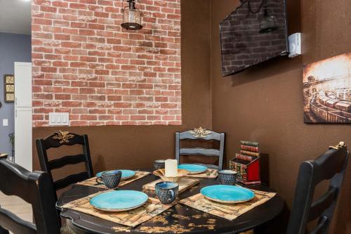 a table with chairs and blue plates on it at Steampunk Haven in the Heart of Tacoma! in Tacoma