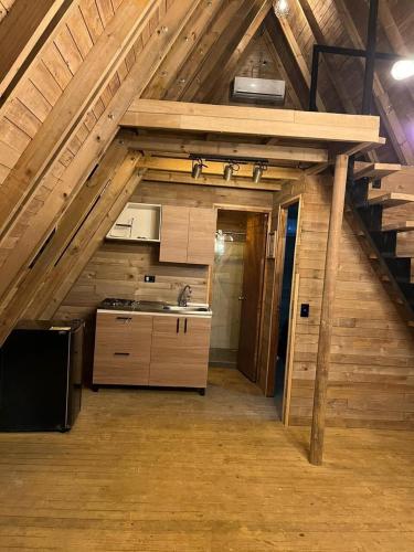 a kitchen with a sink and a stove in an attic at Glamping Verde Melcocho in San Francisco