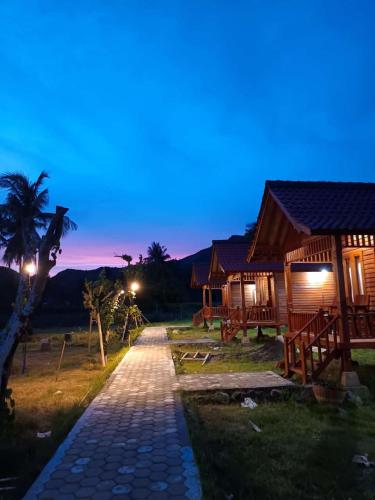 a pathway leading to a cabin at night at Mio Villa Tomang Omang Lombok in Selong Belanak