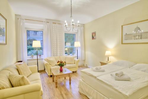 a living room with two beds and a couch at Holiday Berlin Apartments in Berlin