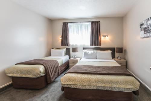 Postel nebo postele na pokoji v ubytování Strathern Motor Lodge