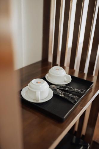 two plates and utensils sitting on a table at TamCoc Peaceful Homestay in Vũ Lâm