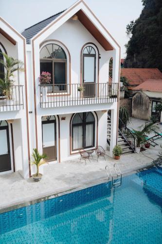 a house with a swimming pool in front of it at TamCoc Peaceful Homestay in Vũ Lâm
