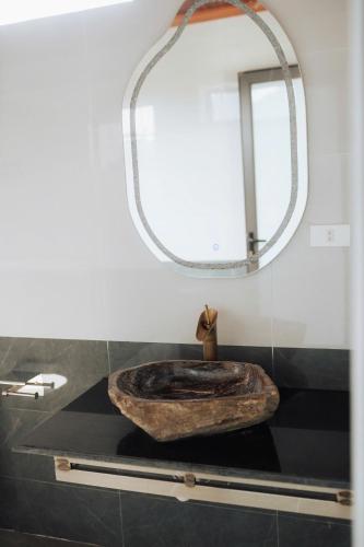 a bathroom with a wooden sink and a mirror at TamCoc Peaceful Homestay in Vũ Lâm