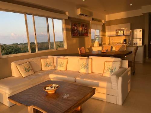 a living room with a white couch and a table at Apartment with sea view in Cozumel