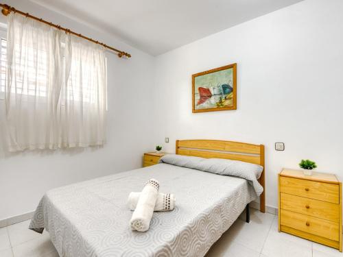 a bedroom with a bed with a stuffed animal on it at Apartment in Roses near beach in Montjoys