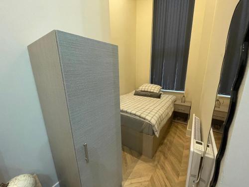 a small room with a small bed in a room at Stylish Apartment in Leeds City Centre in Central Station