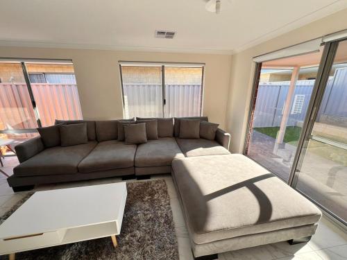 a living room with a couch and a table at The Stanley in Henley Brook