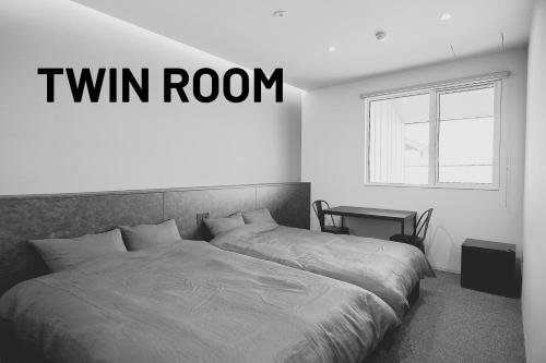 a bedroom with a bed with a twin room at NEW HUMBER in Yubetsu