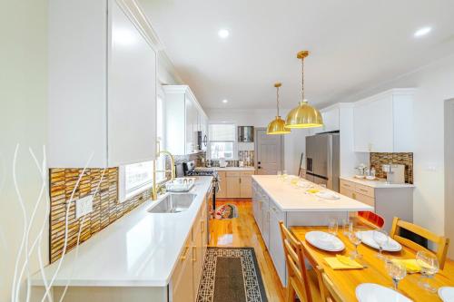 a large kitchen with white cabinets and a long counter at 82 - 3BR Boston - Stylish Stay near MBTA in Boston
