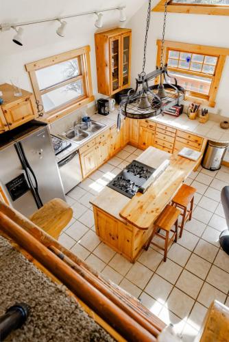 an overhead view of a kitchen with a table and a stove at Cabin-Style Ski Home in Minturn with Private Deck in Minturn
