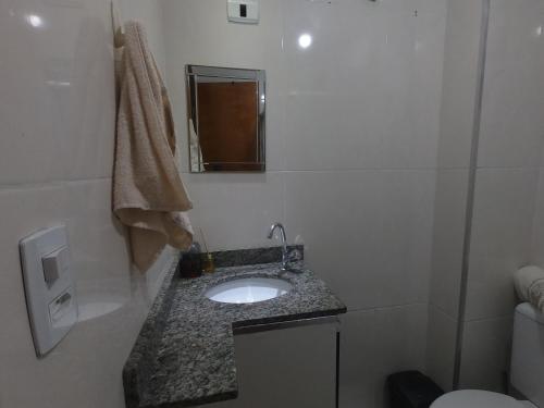 a small bathroom with a sink and a mirror at Apartamento em Campo Grande RJ in Rio de Janeiro