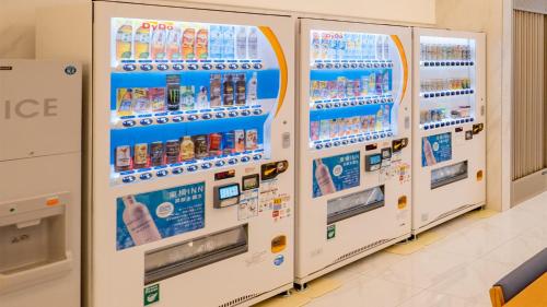 a row of refrigerators in a store with drinks at Toyoko Inn Nagasaki Ekimae in Nagasaki