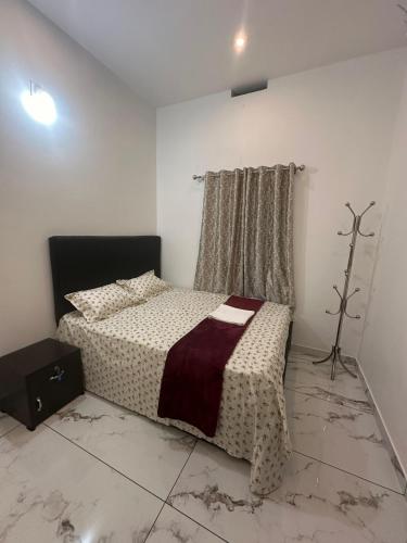 a bedroom with a bed and a window in it at Homie Hub in Meppādi