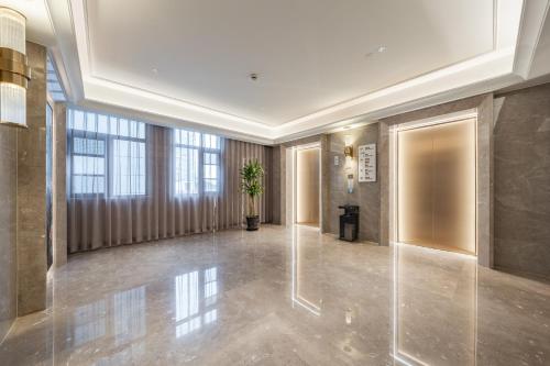 a hallway of a building with a potted plant at Meilun Hotel Shanghai International Tourist Resort in Shanghai