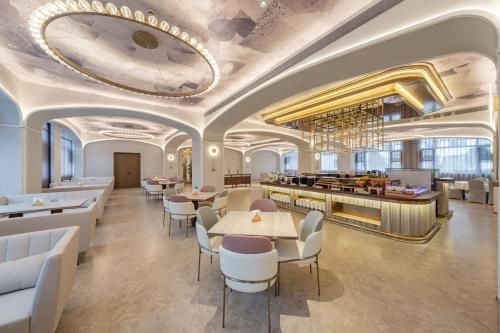 a lobby of a hotel with tables and chairs at Meilun Hotel Shanghai International Tourist Resort in Shanghai