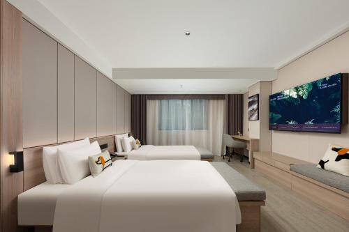 Ένα ή περισσότερα κρεβάτια σε δωμάτιο στο Atour X Hotel Chengdu Taikoo Li General Office Wangfujing