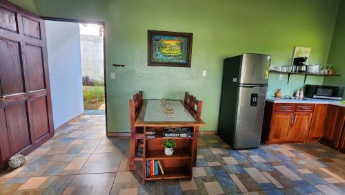 a kitchen with a refrigerator and a table in it at Casa tipica in Fortuna