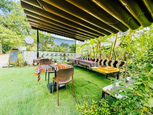 a patio with a table and chairs on the grass at Ninh Binh The View Point Home & Spa in Ninh Binh