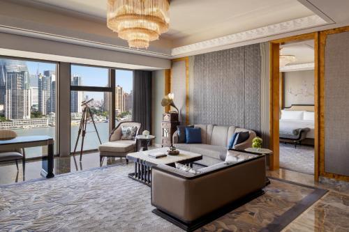 a living room with a couch and a table at The St. Regis on the Bund, Shanghai in Shanghai