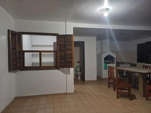 a living room with a table and a dining room at Casa de Praia aconchego in Guaratuba