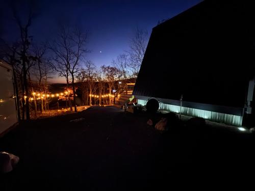 a dark photo of a building at night at The Charlotte A-Frame cabin with mountain views in Wilsonville