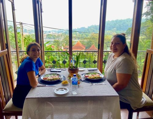a couple of women sitting at a table with food at Sesatha lake Kandy in Kandy