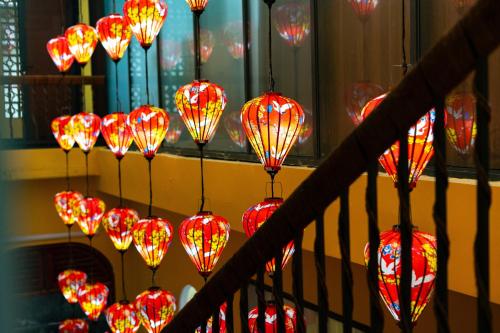a bunch of red lanterns hanging from a staircase at Yo'House Hue Homestay in Hue
