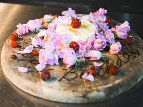 a cake with flowers on top of it on a table at LA TERRA NAGANOーVacation STAY 80689v in Shiojiri