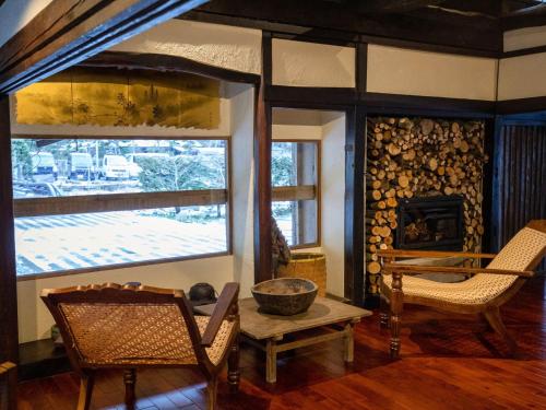 a living room with two chairs and a fireplace at LA TERRA NAGANOーVacation STAY 80689v in Shiojiri