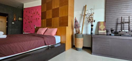 a bedroom with a bed and a sink at Velanon Phuket in Ban Lo Long