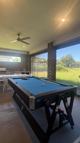 a pool table in a room with a large window at Family-Friendly Gorgeous Farm House TF1952 in Dixons Creek