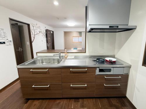 a kitchen with a sink and a counter top at 風花Fuka民泊大森西002 in Tokyo