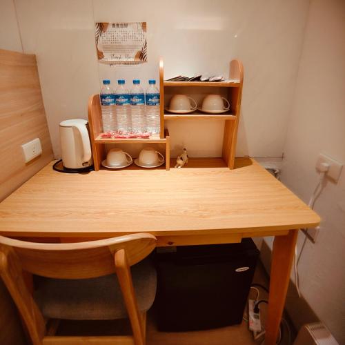 a wooden table with some bottles of water on it at Fooyee Hotel - Yonghe in Yonghe