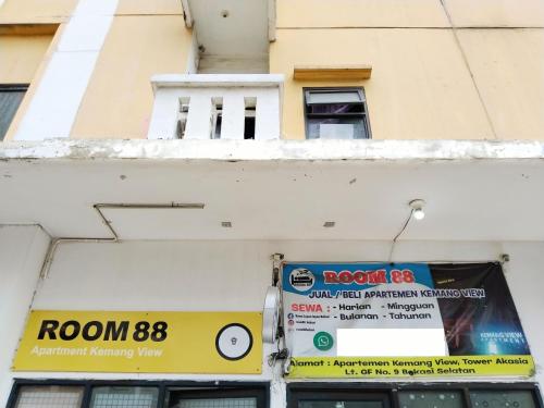 a building with a sign on the side of it at Room 88 Kemang View Apartment Tower Flamboyant in Pekayon Satu