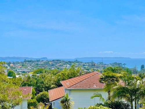 a view of a city from a house at Valley Sea View Villa Torbay in Auckland