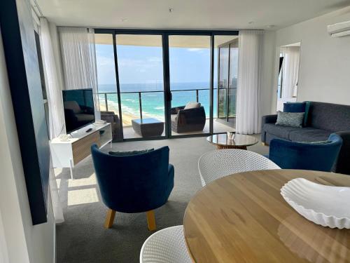 a living room with a view of the ocean at Rhapsody Resort - Official in Gold Coast